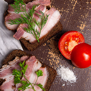 Smoked bacon with rye black bread and tomatoes