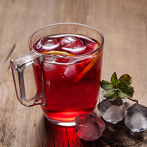 Hibiscus cold tea with ice, lemon and mint 