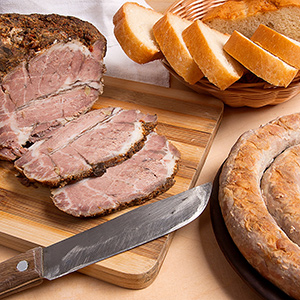 Homemade sausage and baked pork with spices and herbs