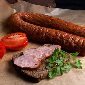 Slices of smoked sausage with spice, herbs and vegetables